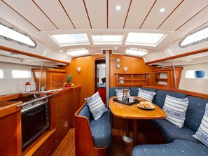 A yacht interior with a galley, seating area, and skylights. - Sun-kissed Sailing Adventure in the Ionian Islands (Preveza)