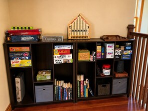 A bookshelf with various board games and books. - Family Friendly House on 26 Acres in the Mountains (Garden Valley)