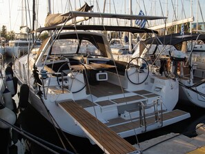 A marina with multiple sailboats docked.