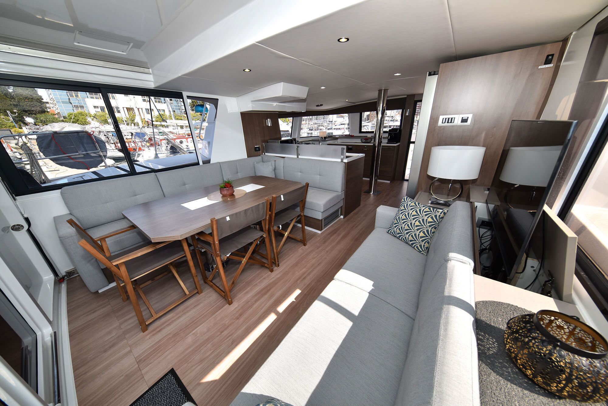 A compact interior with a dining area, sofa, and kitchen.