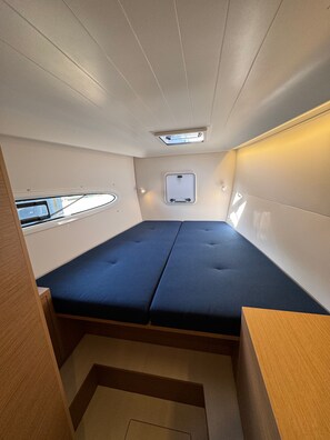 A compact, well-lit interior with a bunk bed, a small window, and a built-in storage cabinet. - Sun-Kissed Sailing Adventure in Sibenik, Croatia (Rogoznica)