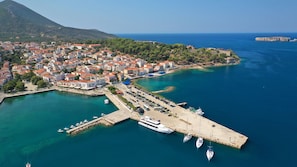 An aerial view of a coastal town with a marina, buildings, and a mountain in the background. - Sun-Kissed Sailing Adventure in Pylos, Peloponeso (Pilos)