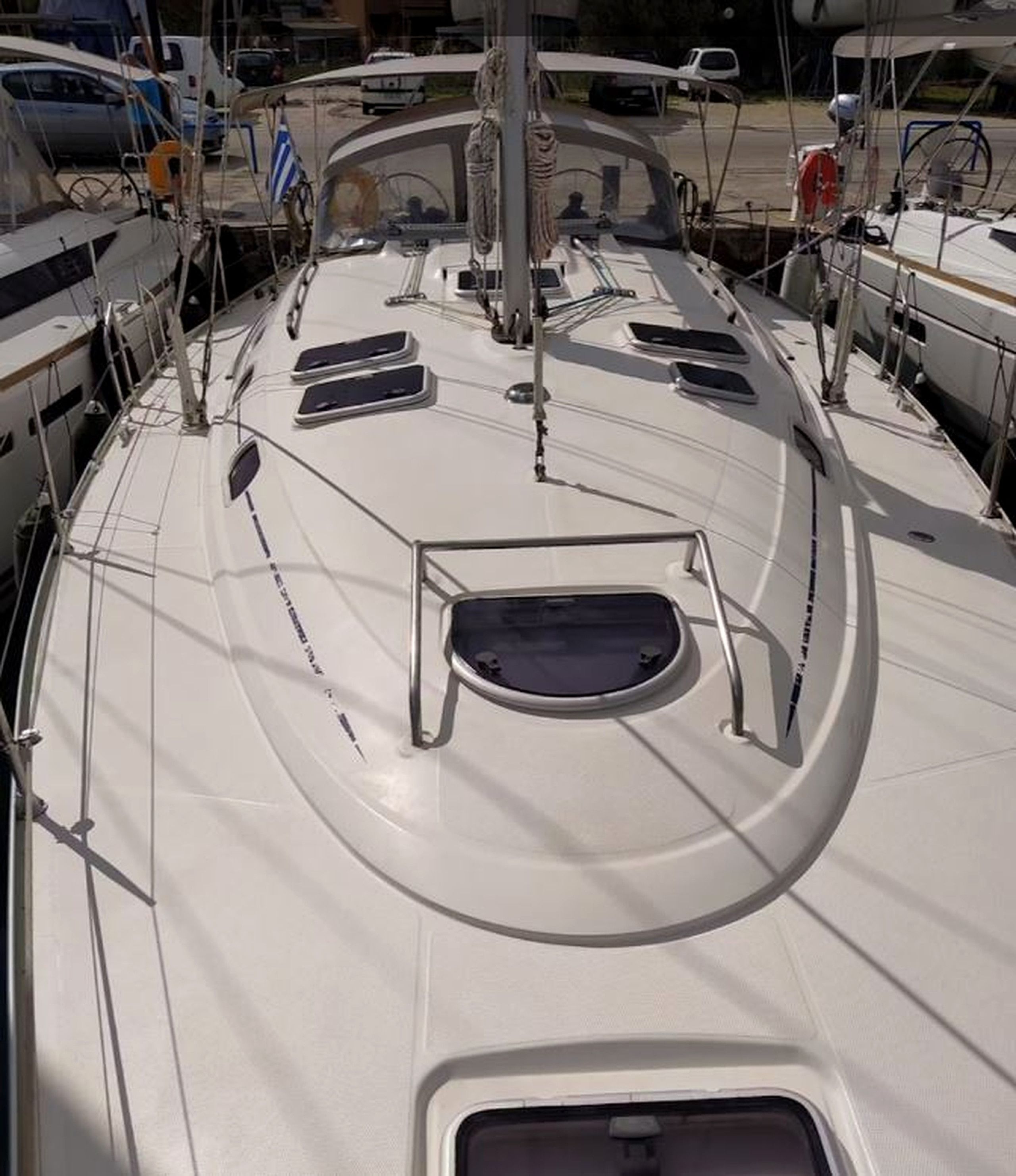 The deck of a sailboat with multiple windows and a central mast.
