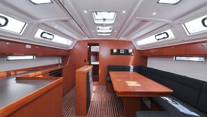 A compact interior with a central dining table, cushioned seating, and skylights. - Sun-Kissed Sailing Adventure in Zadar, Croatia (Zadar)