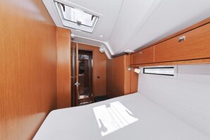 A compact, well-lit interior with a wooden panel wall, a white ceiling, and a small window. - Sun-Kissed Sailing Adventure in Zadar, Croatia (Zadar)