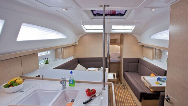 A compact galley with a sink, dining area, and seating. - Sun-Kissed Sailing Adventure in Istria, Croatia (Rabac)