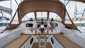 A boat's deck with a table, two wine glasses, a bottle, and a canopy. - Sun-Kissed Sailing Adventure in Istria, Croatia (Rabac)