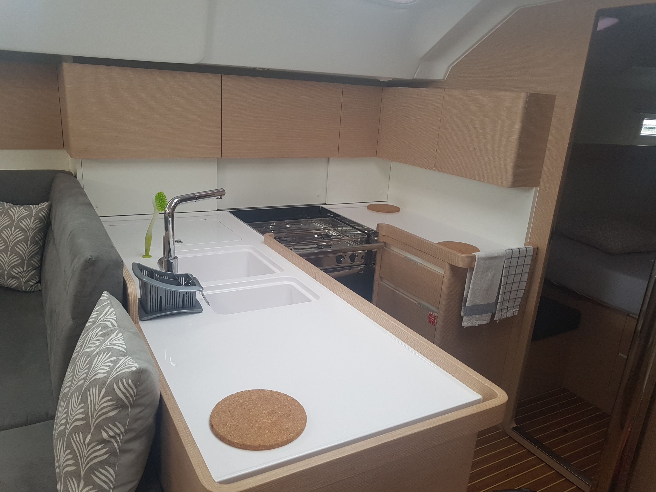 A compact kitchenette with a stove, sink, and a small countertop.