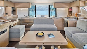 A modern interior with a kitchen, dining area, and seating. - Sun-kissed Sailing Adventure in Split-Dalmatia, Croatia (Trogir)