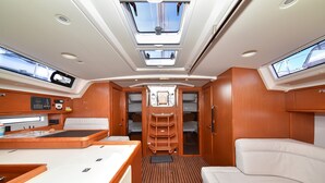 A compact interior with a central seating area, a control panel, and a storage cabinet. - Sun-Kissed Sailing Adventure in Zadar, Croatia (Zadar)