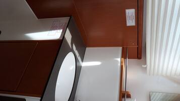 A bathroom with a white sink, a mirror, and a wooden cabinet.