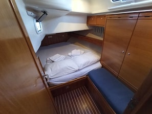 A small cabin with a bunk bed, a small table, and a window.