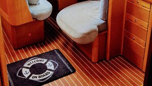 A compact interior with a dining table, two chairs, a small sofa, a TV, and a window. - Sun-Kissed Sailing Adventure in Split-Dalmacia, Croatia (Tucepi)