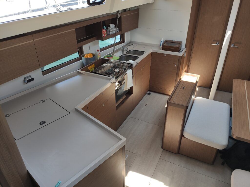 A compact kitchen with a stove, sink, and storage cabinets.