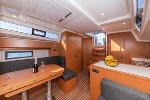A compact galley with a dining table, a seating area, a small kitchen, and a window. - Sun-Kissed Sailing Adventure in Zadar, Croatia (Zadar)