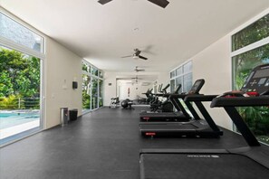 A gym with treadmills, exercise balls, and a ceiling fan. - Rooftop Penthouse | Work Remotely in Akumal (AKUMAL)