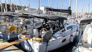 A marina with multiple sailboats docked, including a boat named 'Lady Blue' with a covered deck and a 'IMPRESSION 401' boat with a black canopy. - Sun-Kissed Sailing Adventure in Zadar, Croatia (Zadar)