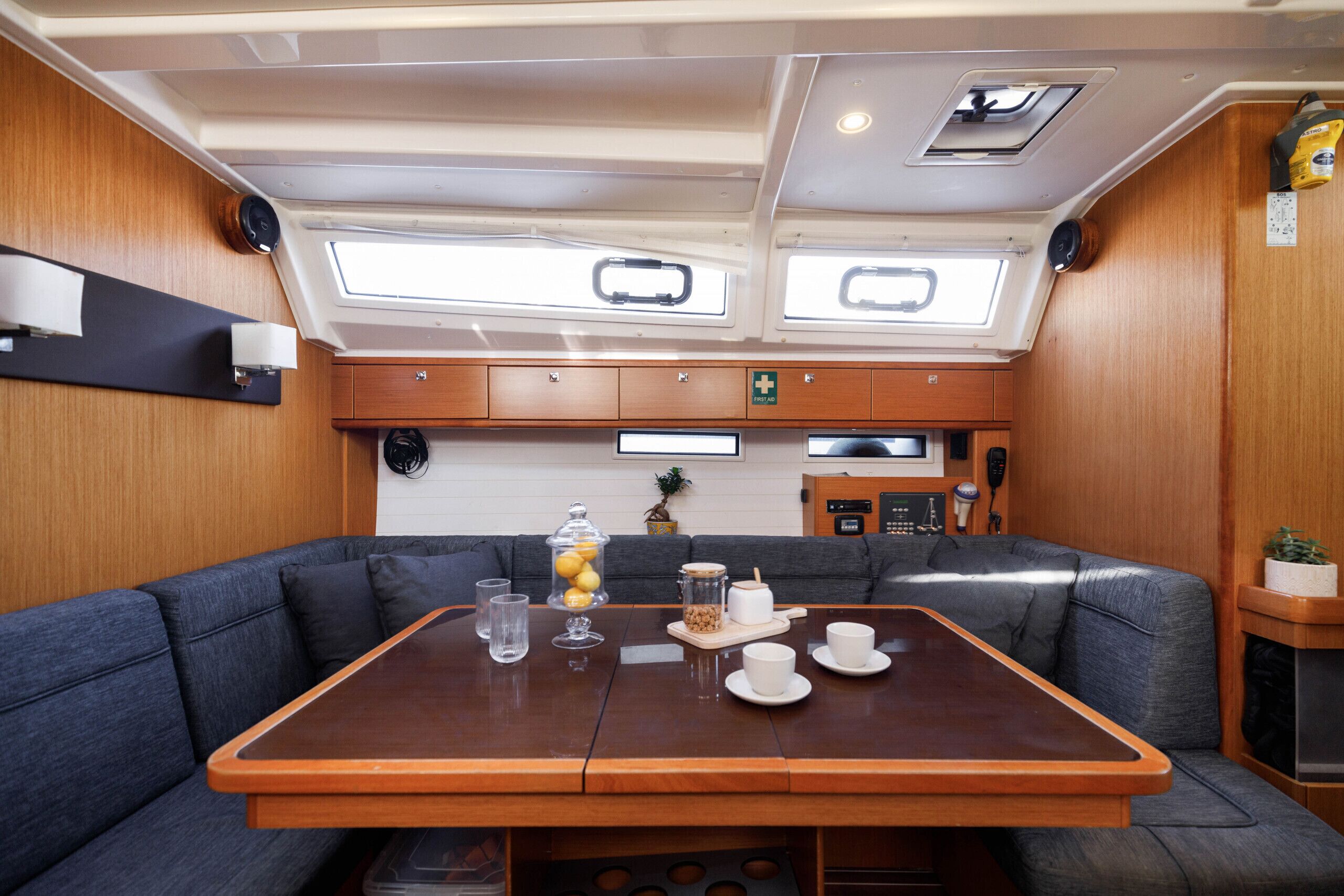 A compact kitchen with a central island, a built-in seating area, and a small refrigerator.