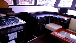 A compact kitchen with a gas stove, oven, and a small sink. - Sun-Kissed Sailing Adventure in Sibenik, Croatia (Primošten)