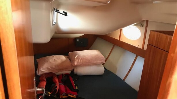 A compact cabin with a bunk bed, a small table, and a storage cabinet. - Sun-Kissed Sailing Adventure in Tenerife, Islas Canarias (Las Galletas)
