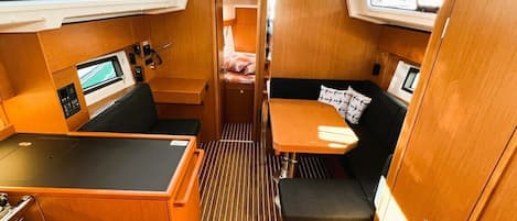 A compact interior with a kitchenette, seating area, and a small table.