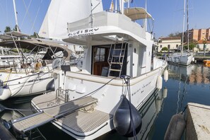 A white yacht named 'Blue Sky' docked at a marina with a covered deck and a small cabin. - Sun-Kissed Sailing Adventure in Zadar, Croatia (Zadar)