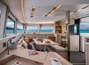 A modern interior with a dining area, seating, and a kitchen.