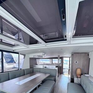 A modern interior with a dining area, seating, and a view of the outside.