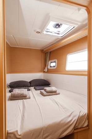 A compact, well-lit interior with a bed, a small window, and a skylight. - Sun-Kissed Sailing Adventure in the Ionian Islands, Lefkada (Lefkada)