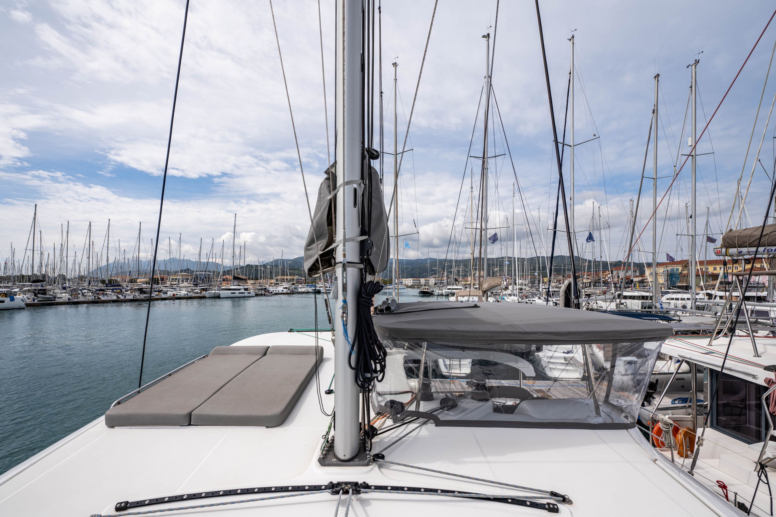 A marina with multiple sailboats docked.