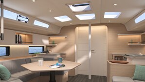 Ein modernes Wohnmobil-Interieur mit Essbereich, Sitzgelegenheiten, einer Küche und einem Fernseher.