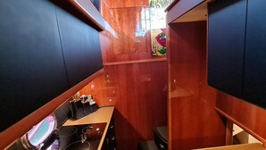 A compact kitchen with a sink, stove, and cabinets.