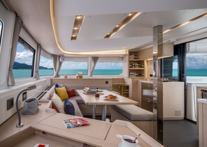 A modern interior with a dining area, kitchen, and seating.