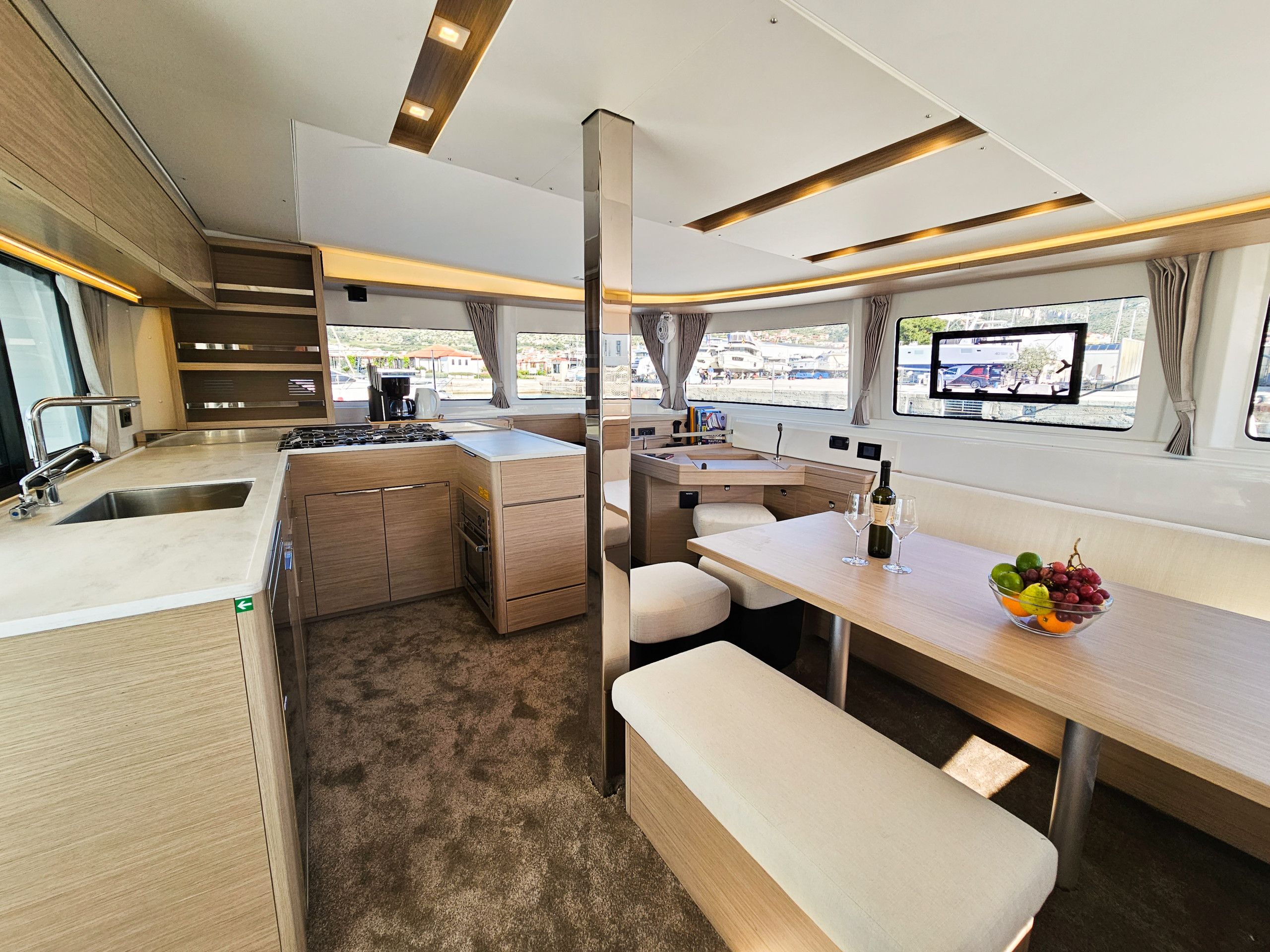 A compact kitchen with a sink, stove, and seating area.