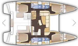 A layout of a boat interior with a dining area, kitchen, and seating arrangements.