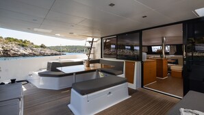 A modern boat interior with a dining area, seating, and a kitchen. - Sun-Kissed Sailing Adventure in Sibenik, Croatia (Primošten)