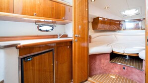 A compact galley with wooden cabinetry, a sink, and a compact kitchenette. - Sibenik Sun-soaked Sailing: A Luxurious Croatian Voyage (Pirovac)