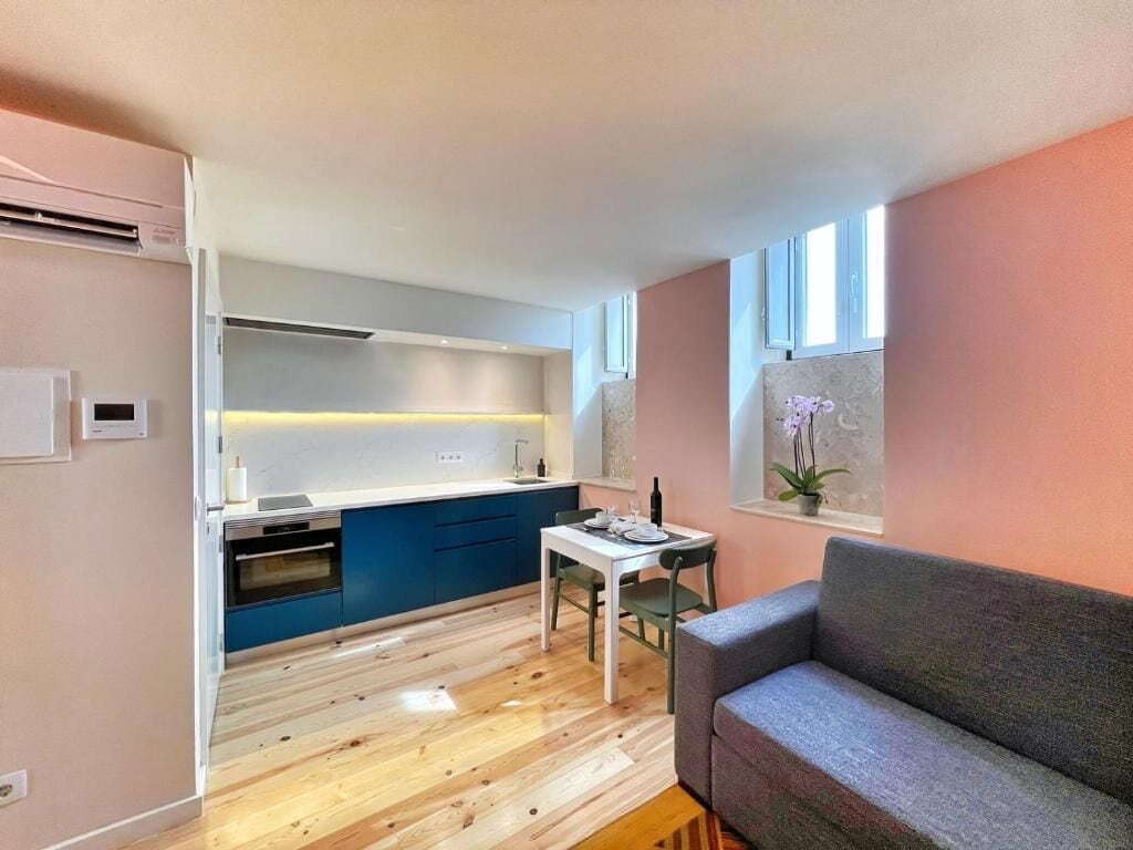 A compact living space with a kitchenette, a dining area, and a seating area.