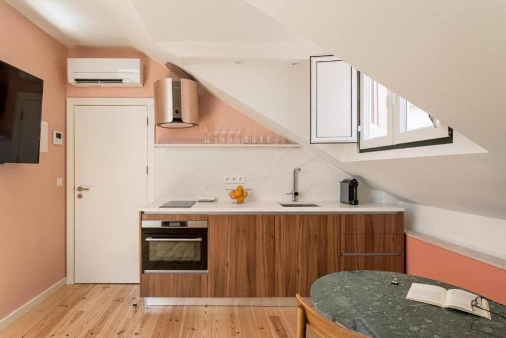 A compact kitchen with wooden cabinets, a built-in oven, and a small countertop.