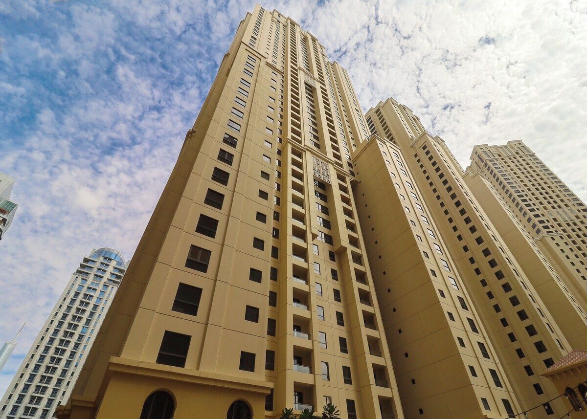 A high-rise building with multiple floors, large windows, and a modern architectural design.