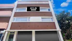 A multi-story hotel with a sign reading 'HOTELO' and a company-serviced logo. - Saver Double Hotel O Chandigarh Road (Dera Bassi)