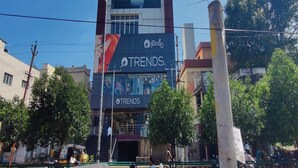 A multi-story building with a prominent 'FOR RENT' sign on the upper level.