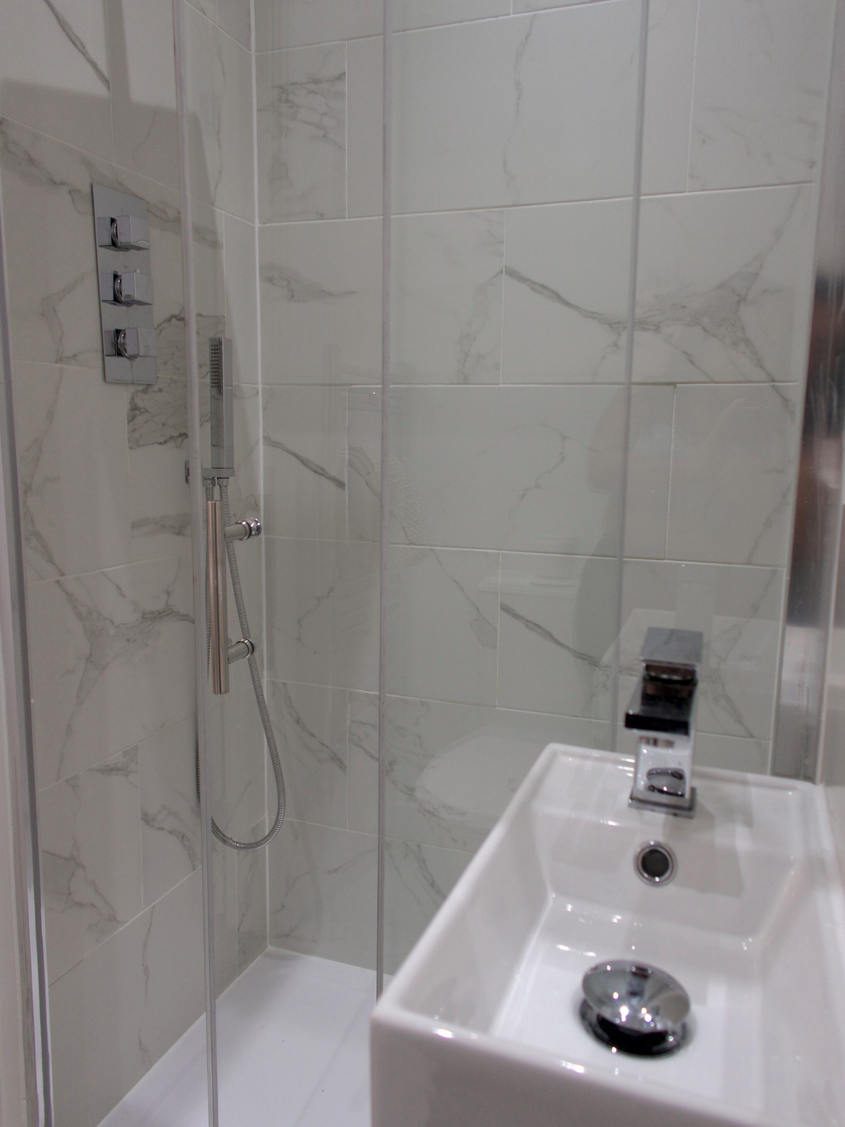 Shower, hair dryer, towels, toilet paper