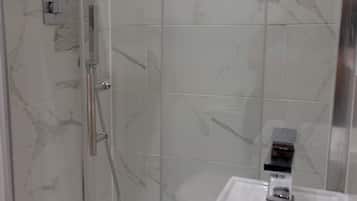 Shower, hair dryer, towels, toilet paper