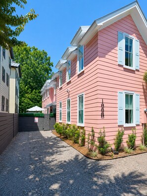 A pink building with white shutters, a gravel driveway, and a small garden area. - Private Pool - 1 Block to King St - 4 Bedrooms (Charleston)