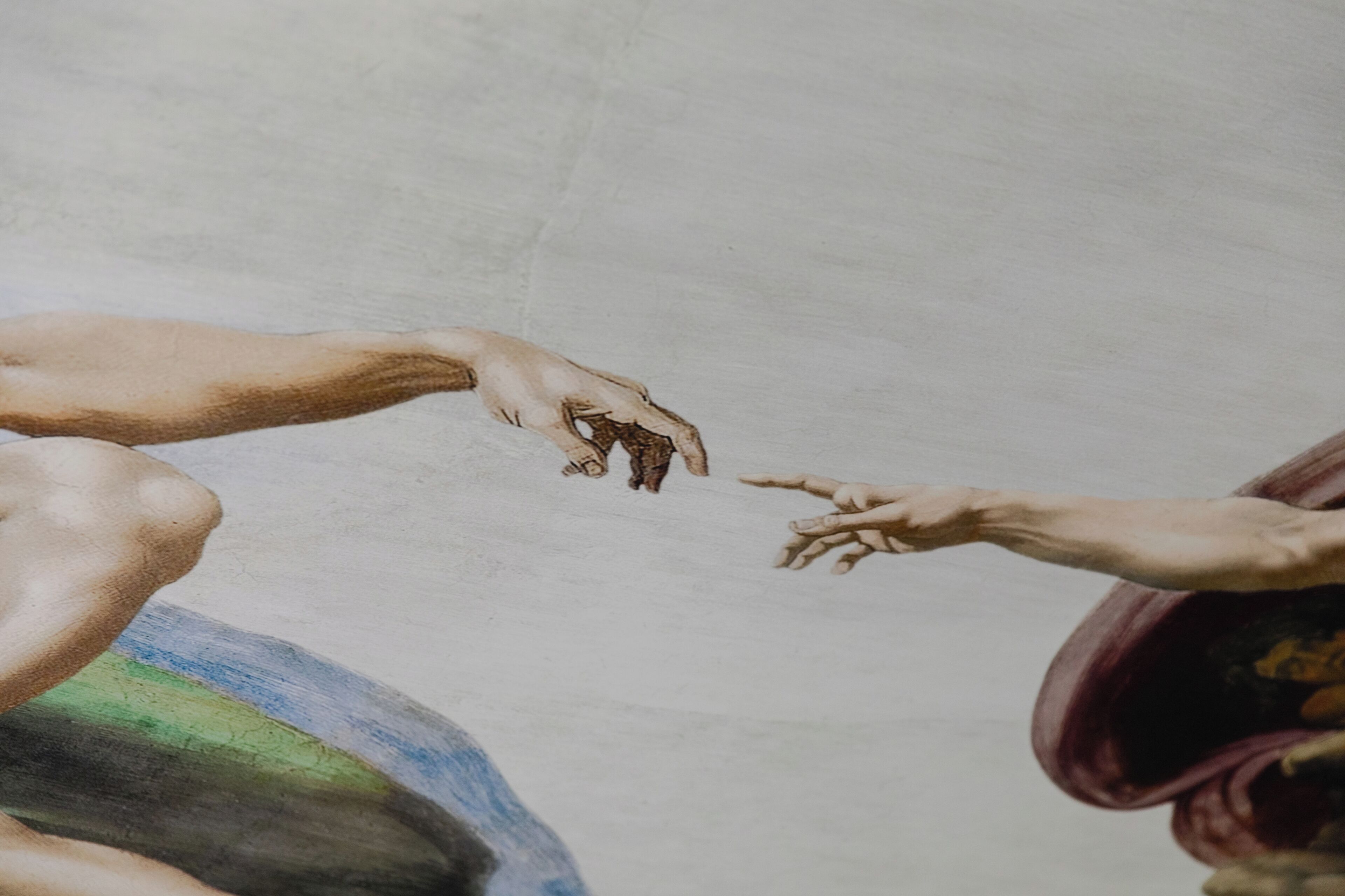A fresco with human figures reaching towards each other.