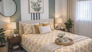A bedroom with a bed, bedside tables, a mirror, a wall-mounted plant, and a window with curtains. - 5640 NE Miami (Miami)