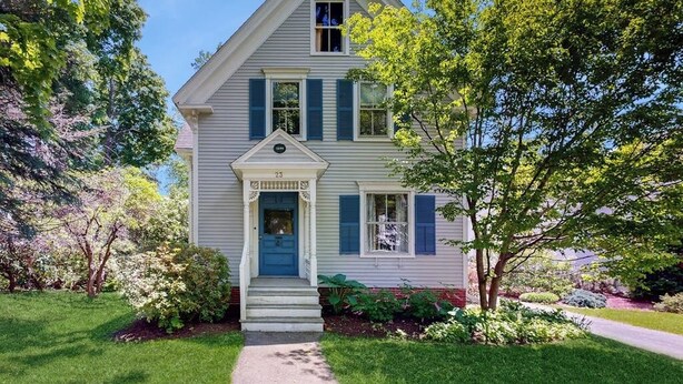 A two-story house with a front porch, a blue door, and a small garden. - Parker House: Historic Home - Walk Downtown, Dog-friendly & Washer/dryer (Camden)
