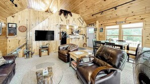 A cozy cabin interior with a living room, dining area, and kitchen. - Lakefront Cabin on First Roach Pond With Dock, Lake View & Firepit- Dog-friendly (Greenville)