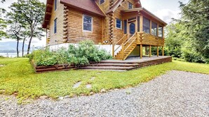 A log cabin with a porch, a staircase, and a view of the surrounding landscape. - Tranquil Haven Secluded Waterfront House With Sauna, Dock, Kayaks, Canoe, gym (Greenville)